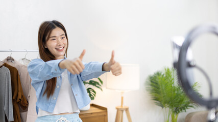 Beautiful woman with a social media influence is greeting the audience for recording vlog video live streaming, Online fashion clothing business, Using psychology to generate interest in customers.