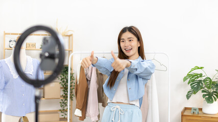 Beautiful woman with a social media influence is greeting the audience for recording vlog video...