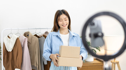 Woman with a social media influence is greeting the audience for recording vlog video live...