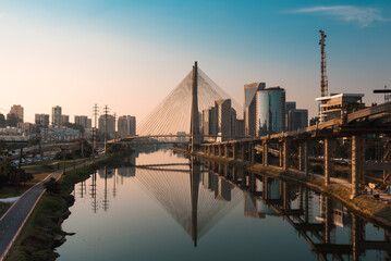 View of Pinheiros River With Modern Buildings Alongside and Famous Octavio Frias de Oliveira Bridge...