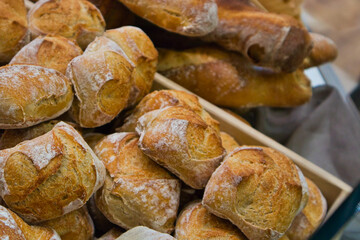 Wooden basket filled with small bread buns. Wooden box with tasty, crisp, fresh buns inside. Freshly bake little bread buns in a German bakery. Bakery excellence and perfection. Traditional craft. 