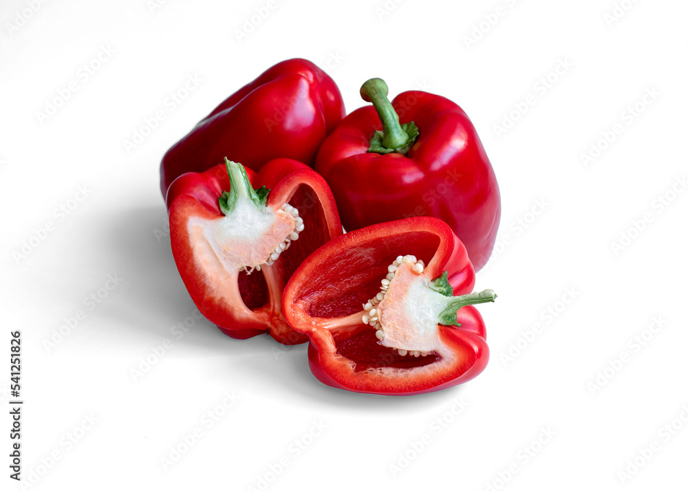 Wall mural red sweet pepper isolated on white background. food concept. two red ripe sweet peppers and one half