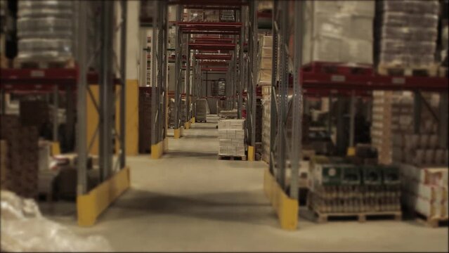A new warehouse with racks for storing things and products in bags and boxes. Business, logistics.