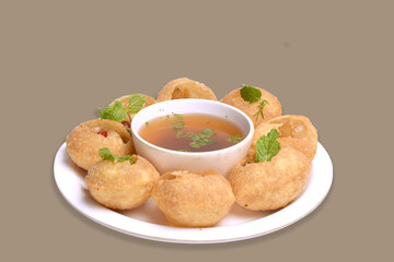 Delicious north and south indian street food pani puri gol gappa with tamarind water served in white plate and potato and chickpeas - obrazy, fototapety, plakaty