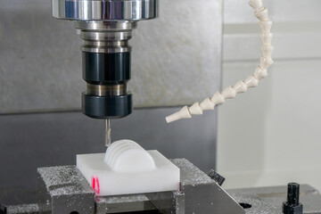 The  CNC milling machine cutting the nylon 6 material part with ball end mill tool.