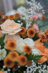 Moden wedding decoration indoors with multi floral ambience. Orange accent flowers. White and Orange theme wedding ceremony. Intimacy family dinners. 