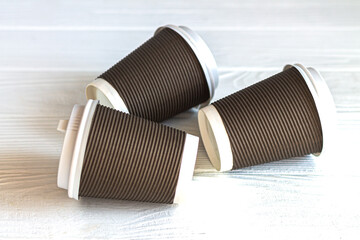 Disposable paper coffee cup on white table