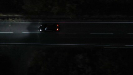 Aerial view to a car on the road at night