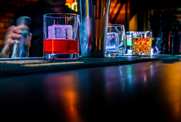 woman hand bartender making negroni cocktail in bar