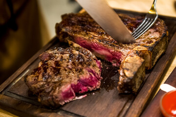 Steak on a wooden board in a restaurant