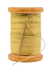 An old wooden spool of thread and a needle on a white background close-up. Threads for sewing