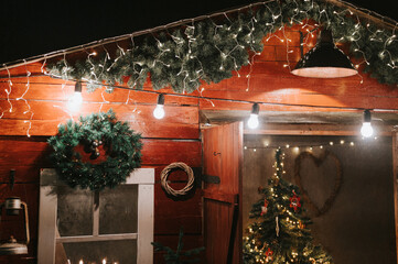 christmas and new year time. christmas decor of the exterior of a rural wooden house and roof....