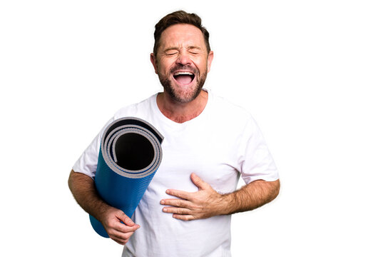 Middle Age Man Laughing Out Loud At Some Hilarious Joke. With A Yoga Matt. Fitness Concept