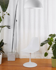 Vintage minimalist white tulip chair. Interior product scene with retro space age chair, luxurious curtains, large house plants, and a white 1970s arc lamp.