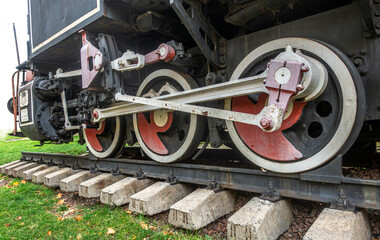 Fototapeta premium Wheels of an old steam locomotive, movement concept