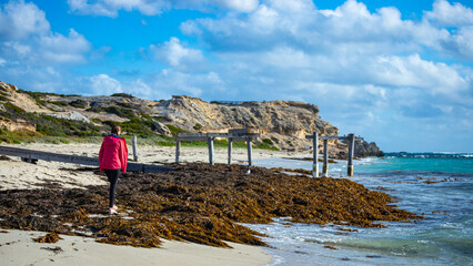 happy girl walks on the famous stingray beach in hamelin bay, near margaret river in western...