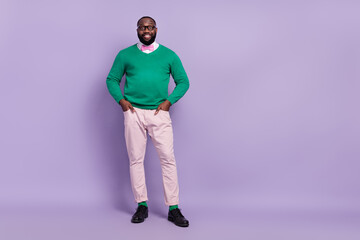 Fototapeta premium Full body photo of young attractive cheerful gentleman in trendy clothes outfit isolated on purple color background