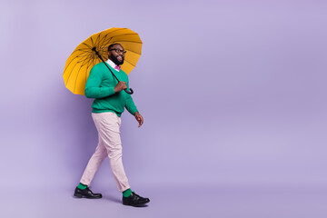 Full body image of young handsome gentleman go on romantic date under rain isolated on purple color background © deagreez