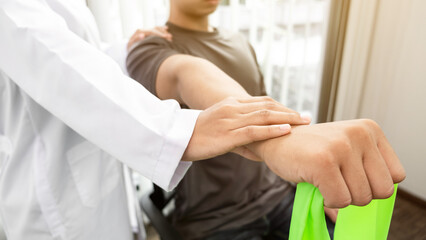 Therapist treating a male injured by shoulder impingement test.