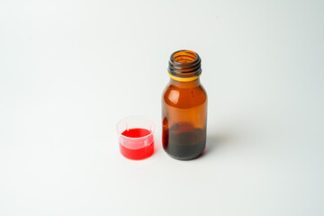 health concept, medicine and medicine - medicine bottle or syrup and antipyretic spoon