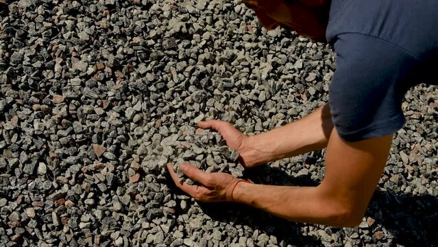 A man holds a rubble in his hands. Selective focus.