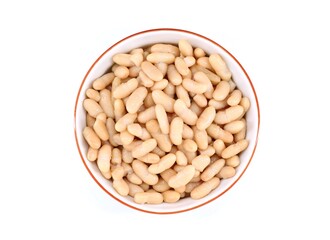 Boiled white kidney beans in a ceramic bowl on white background. Top view.