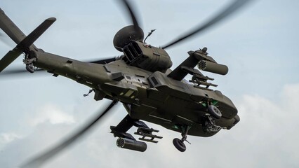 close-up three quarter view of ZM707 British army Boeing Apache Attack helicopter (AH-64E ArmyAir606) in flight banking away overhead  © Martin