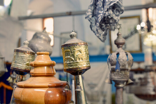 a beautifully ornate blue  case with golden bells and crowns (rimmonim) and other decorations in a synagogue in israel sefad