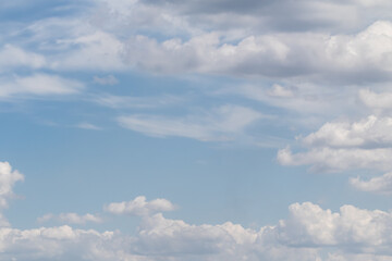Fototapeta na wymiar White clouds on the blue sky, bright background of the summer sky.