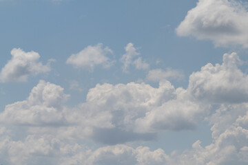 Naklejka na ściany i meble White clouds on the blue sky, bright background of the summer sky.