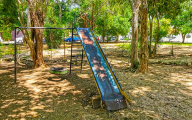 Green city park playground bench slide swing Playa del Carmen.
