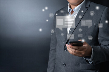 Close up businessman pushing, touching on smartphone with virtual emotion icon on black and gray background