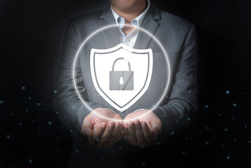 Double exposure of close up businessman holding security with key icon on balck and gray background