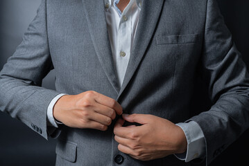 Businessman wearing a black gray suit on black background