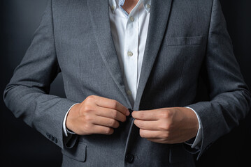 Businessman wearing a black gray suit on black background