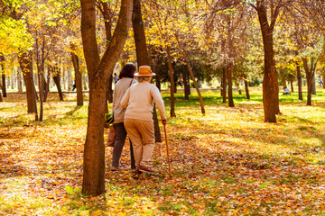 Fototapeta premium Woman accompanies older woman with stick