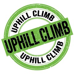 UPHILL CLIMB text written on green-black round stamp sign