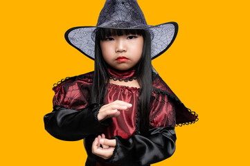 Portrait of asian little girl wear witch costume,Halloween festival concept