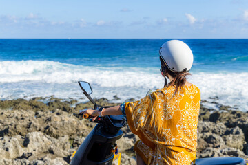 Travel Woman ride a motor bike in liuqiu island at Taiwan