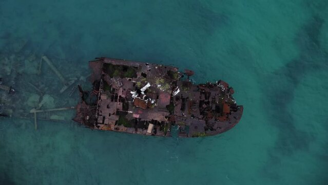 Top view of Rocky cay aground ship on calm turquoise sea waves in San Andres Island, Colombia