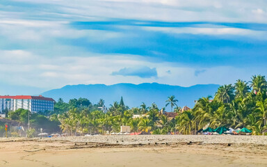 Palms parasols sun loungers beach resort Zicatela Puerto Escondido Mexico.