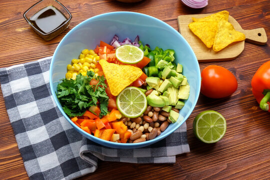 Cowboy caviar is traditional mexican vegetable salad. Corn, beans, tomatoes, peppers, onions lime avocado