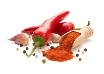 Wall murals Hot chili peppers Hot red pepper ground on a white background. Whole hot peppers