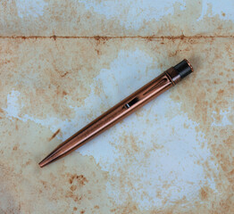Vintage pen on faded paper texture background
