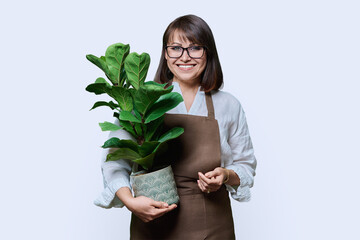 Woman in apron with potted plant, on white background