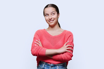 Fototapeta premium Teenage girl with thoughtful expression, on white studio background