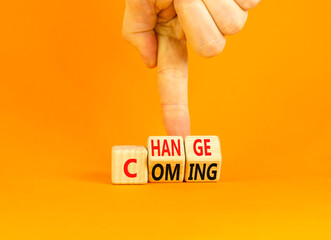 Change is coming symbol. Concept words Change and Coming on wooden cubes. Beautiful orange table orange background. Businessman hand. Business change is coming concept. Copy space.