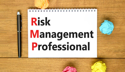 RMP risk management professional symbol. Concept words RMP risk management professional on white note on a beautiful wooden background. Business RMP risk management professional concept. Copy space.