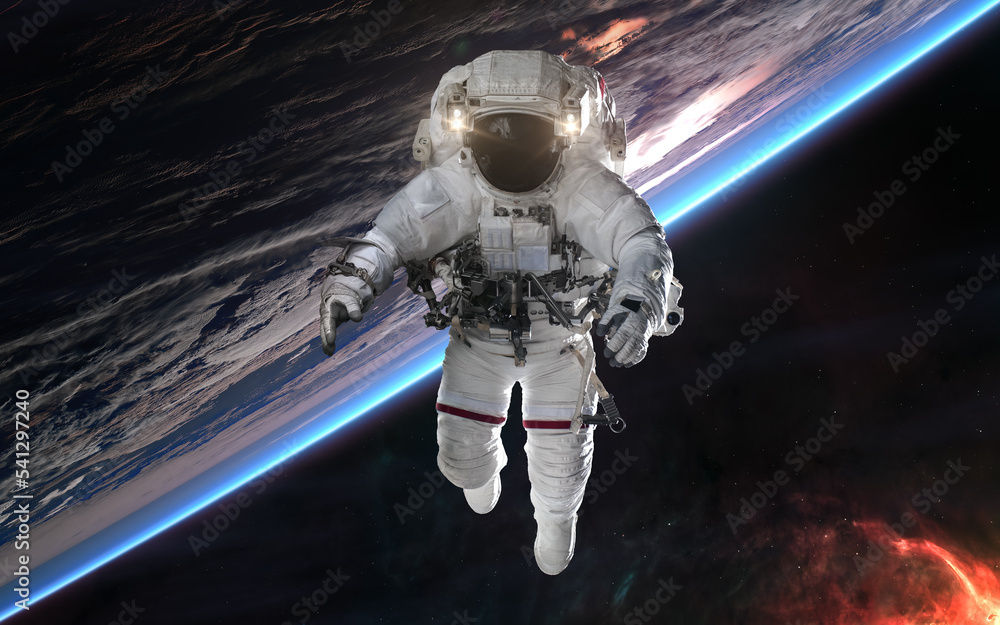 Wall mural astronaut in outer space orbiting earth. solar system. science fiction. elements of this image furni
