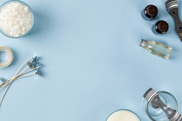 Tools, Equipment for candles making. Jar with wick, coconut or organic soy wax, fragrance. Flatlay, top view. Copy space. Blue background
